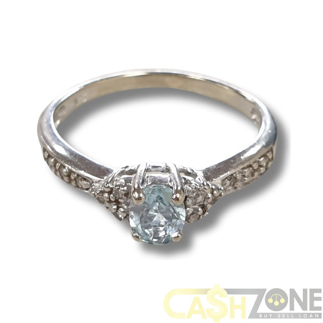 9CT White Gold Ladies Ring W/Pale Blue Stone